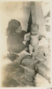Image: Odie, 7 months, son of Etook-a-shoo, showing a can of Shefield milk. [Ole Petersen and his mother, Ane]